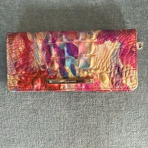 Brahmin “Ady” wallet. Dimensions 7.5”w 3.5”h .5”d. 13 card slots and 1 ID slot.